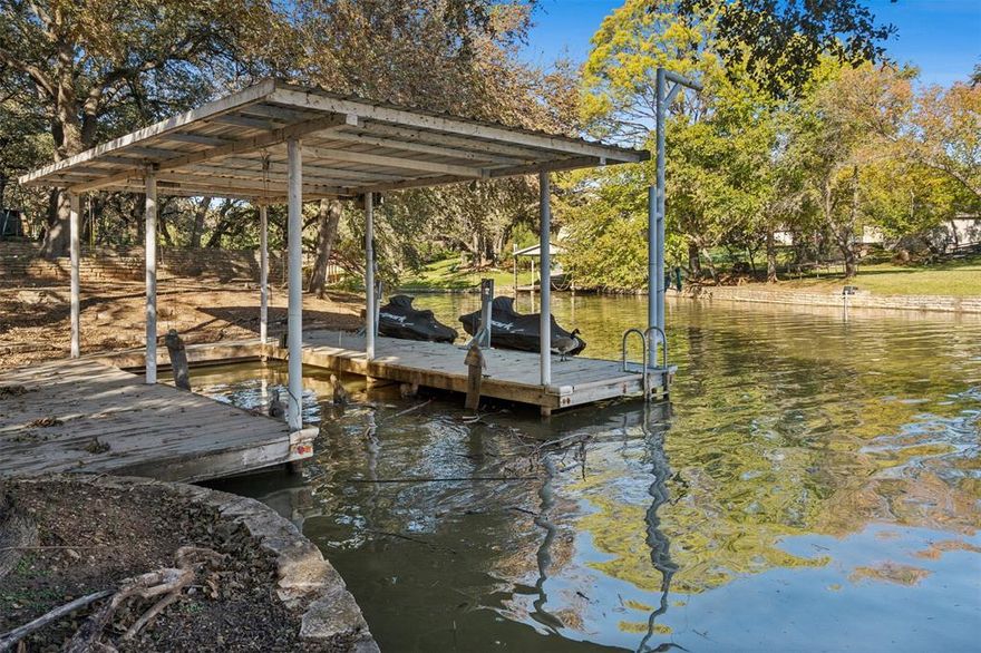 WATERFRONT turn key LAKE HOUSE featuring a private boat dock with a 10' wide slip with lift and two personal water craft lifts! Tucked away on a quiet street just 4 minutes from downtown Granbury Square. Fully renovated 3 bedrooms, 2 bathrooms with wood tile throughout. Tandem 2 car garage. Beautiful back yard with mature shade trees overlooking the water. Great patio and backyard with concrete walkway to the dock. Huge shed for all your storage needs. Storm shelter. Furnishing and personal water crafts are negotiable.