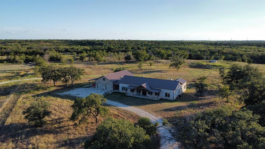 Unwind on the Tres Reinas Ranch, blending a scenic Texas landscape with luxury living. Featuring a sprawling 320 acres offering exceptional privacy and tranquility. This turnkey ranch estate has a new construction home built in 2024 offering 3,208 sq ft that boasts 4 bedrooms and 3 baths and a large custom garage.

The ranch-style home has vaulted ceilings, an open-concept floor plan, and exquisite custom touches of granite countertops, vaulted ceilings, dramatic windows throughout, and exposed beams. A chef's kitchen with premier appliances, custom cabinets, a double oven, a walk-in pantry, and a large island featuring a magnificent granite countertop. The living area is refined with a stone gas fireplace, built-in cabinets, and decorative lighting. The master bedroom also features large windows for sunrise views, dual vanities, a garden tub, a custom shower, and an ample walk-in closet. The remaining three bedrooms are spacious and offer large closets. There is additionally a safe room and laundry room, and this home has a Generac generator. The home has a large attached insulated garage that has electricity and is piped for plumbing.

The land is serene with 3 tanks, a water well with an aerator, 3 water stations for livestock, rural water, and the iconic Bluff Creek runs throughout the southern portion of the property. This property comes with all the equipment needed for a small cattle operation, offering 4 cows, 2 bull calves, and 1 heifer that are F1 Angus Akaushi. There is a new Priefert chute, a sweep alley, and a new Bobcat skid steer with implements. There are additionally two bee boxes (hive bodies) for harvesting ranch honey! All new fencing, cross fencing, and a gated pipe entry. This ranch is turnkey and comes fully furnished. 

The Tres Reinas Ranch is where luxury meets sophistication. Come explore this turnkey, unparalleled ranch property featuring privacy and seclusion with luxurious living spaces, exceptional acreage, and opulence.