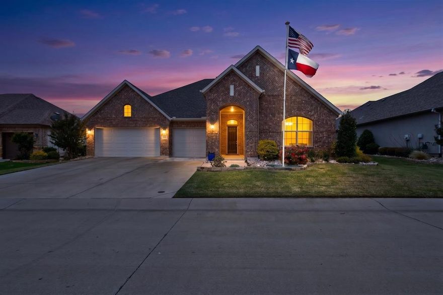 Welcome to this stunning all-brick Ashland two-story home—a rare find in a desirable 55+ community that perfectly blends timeless elegance, thoughtful accessibility, and low-maintenance living.

A stately permanent lighted flagpole greets you with quiet patriotism, full three-car garage with keypad. Step inside through the gracious circular foyer and immediately feel at home.

 Beautiful hardwood floors grace the living areas, including the inviting living room where a ceiling fan and built-in recessed ceiling speakers for relaxed evenings or lively gatherings.

The gourmet kitchen is the heart of the home, featuring a generous center island with seating, elegant crown molding, sparkling quartz countertops, designer pendant lighting, and custom maple cabinets with dovetailed soft-close drawers. Every detail has been considered: a convenient trash compactor, electric cooktop, Blanco sink, soap dispenser, a large walk-in pantry, and a butler’s pantry.

The dining room offers refined charm with its tray ceiling, crown molding, and bay window.

The primary suite, a true sanctuary with a bay window, tray ceiling, crown molding, and ceiling fan. The spa-inspired en-suite bath includes dual quartz vanities, makeup seating area, and a curbless walk-in shower with decorative banding, a bench seat, and an assist bar—thoughtfully designed for comfort.

The guest bedroom has a double closet and tub-shower combination. The first-floor office provides ideal space for working from home or quiet reading.

Upstairs, an expansive open loft with its own bath offers endless possibilities—whether you envision a guest bedroom, game room, music studio, craft room or a welcoming hangout for the grandkids.

This home has been thoughtfully upgraded : pre-wiring for holiday lighting, illuminated stairway steps, generous under-stair storage, a whole-house surge protector, a variable-speed HVAC fan for quiet comfort, and a large patio with TV hookup—perfect for outdoor enjoyment