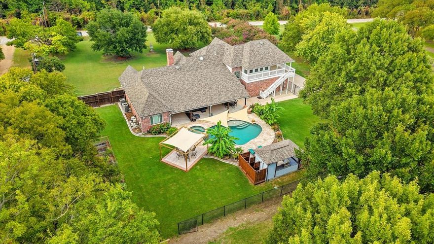 This rare 4-bedroom, 3.5-bathroom estate in Rowlett offers the perfect blend of luxury, privacy, and modern convenience—just steps from Lake Ray Hubbard. Set on nearly three wooded acres directly across from a greenbelt with a forest-like feel, this fully renovated home brings country serenity to the heart of Dallas County. Inside, you'll find an open-concept layout with fresh paint throughout, real wood floors, and custom designer tilework. The kitchen features new appliances, sleek quartz countertops, and seamless flow into the main living and dining areas. The first-floor primary suite is a private retreat with marble bathroom floors, dual room-sized walk-in closets, and a built-in office nook. Even the laundry room stuns with exotic granite counters and bonus space for crafts or storage.

Every major system has been thoughtfully upgraded, including a new impact-resistant roof, smart security with Vivint, smart locks on all exterior doors, and multiple cameras for peace of mind. The home also includes a whole-house water filtration and softener system, energy-efficient and impact-resistant windows, and three newly replaced HVAC systems with Nest thermostats. Outdoor living is just as impressive with a massive covered patio, second-story balcony, full outdoor kitchen and bar, paver patio for a fire pit, outdoor shower, and a sparkling pool with an IntelliChem system that automatically monitors and balances water levels. Additional highlights include a newly built barn, pasture fencing, greenhouse, and an oversized two-car garage ready for projects or storage.

Located in a peaceful pocket of Rowlett with quick access to the lake and local conveniences, this property offers a lifestyle that’s truly one of a kind. If you’re searching for a luxury retreat with land and lake proximity, this is the one you’ve been waiting for.