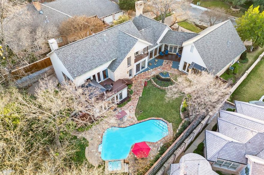 Situated on a beautifully landscaped sloping lot on a secluded cul-de-sac, this tranquil home offers a private location and a refreshingly unique design on four levels. Striking yet unassuming from the street, the interior of the house has expansive interiors and fantastic back yard. Walls of windows from nearly every room allow for tons of natural light plus fantastic views of the incredible, multi-level, park-like back yard. Lush landscaping and towering trees frame the outdoor paradise complete with covered porch, covered upper deck area, a grassy lawn and sparkling pool. The back yard is devoid of power lines and is 100% private every day of the year. The comfortable interior features 4,532 square feet of space with 4 bedrooms, 4 full bathrooms, 2 living areas, 2 dining areas, a handsome study, and a 2-car attached garage. High ceilings, abundant natural light, hardwood floors, marble countertops, custom millwork, and many other features are highlights of this exceptional home.