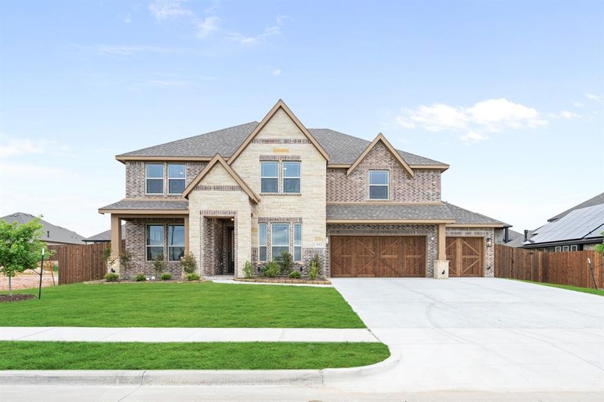 New & Never Lived In! Ready to Close Quick! The Bellflower IV by Bloomfield Homes is a spacious 5 bedroom, 4.5 bathroom, 2-story home with a 3-car garage—set on an oversized interior lot that gives you extra space to spread out both inside and out. Curb appeal starts strong with an upgraded stone-and-brick exterior, a welcoming covered front porch, and a tall 8' front door that makes a grand first impression. Step inside to soaring 2-story ceilings in the family room, creating an open and airy feel with natural light pouring in through large windows. The Deluxe Kitchen is built for both everyday function and entertaining—featuring built-in stainless steel appliances, a gas cooktop, double oven, quartz countertops, and a large island with plenty of workspace. Window coverings are already installed throughout the home for added comfort and privacy. Anchoring the main living area is a stunning stone fireplace that stretches from floor to ceiling, complete with a gas starter and cedar mantel—perfect for cozy nights in. Vaulted ceilings and upgraded finishes throughout give the home a light, upscale feel. The Primary Suite is located on the main floor and includes a large walk-in closet, dual vanities, and a spa-like bath with a soaking tub and separate shower. Upstairs, you'll find a second Primary Suite—perfect for guests or multi-generational living—complete with its own walk-in closet and private bath. Also upstairs is a large game room and additional bedrooms, each with direct bathroom access, giving everyone their own space. Full gutters are already installed, and the oversized lot offers extra room for outdoor living or play. Built by Bloomfield Homes with thoughtful design and quality construction, the Bellflower IV is made for comfort, convenience, and timeless style. Come make it yours at Daniel Farms in DeSoto!