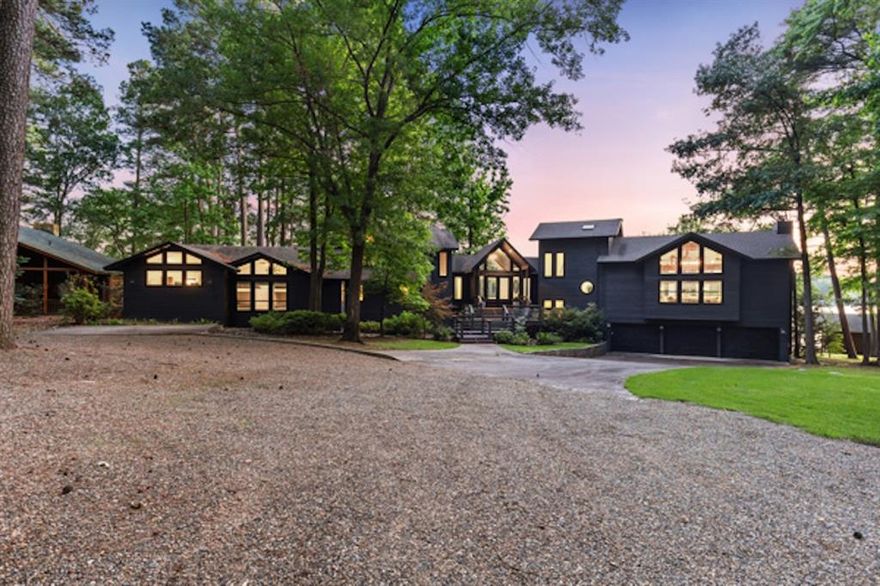 Sprawling lakefront estate, located in the exclusive gated community of Eagle Point on Cypress Springs, offers the ultimate in luxury living. With over 5,200 SF of meticulously designed space, the home is situated on a rare 1.1 acre lot boasting more than 200 feet of pristine shoreline. Positioned to capture breathtaking views of the lake, the property promises some of the most spectacular sunsets. Inside, the residence features six bedrooms and five and a half baths, thoughtfully laid out to accommodate large families and provide ample space for guests. Two master suites provide ultimate privacy, while a fabulous bunk room offers a perfect retreat for children or additional guests. The heart of the home is the chef's kitchen, equipped with state of the art appliances, an oversized island, and a wall of windows that provide unobstructed views of the lake. The property features two living areas, making this home ideal for both everyday living and large scale entertaining. The home also features a well appointed bar area off one of the living spaces, complete with a hidden mini dishwasher for seamless entertaining. Just beyond the second living area is a built-in coffee bar. Step outside and discover the incredible outdoor living spaces that make this estate truly unique. A highlight is the outdoor man cave, an extraordinary entertaining space with a glass roll up door, granite bar, and grilling area. A stone fire pit, positioned above the shoreline, provides a cozy atmosphere for winter nights by the lake, while a hot tub offers the perfect spot for relaxation. Property includes a two slip boathouse with an oversized partially covered deck. A screened-in patio off the kitchen adds an extra dimension to the outdoor experience. The estate is completed with an oversized three car garage and ample parking for guests. Whether you are seeking a serene retreat or a place to entertain in style, this magnificent home is truly a once in a lifetime opportunity. SOLD FURNISHED