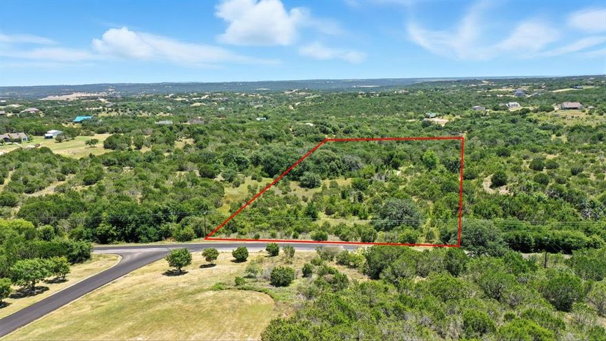 Beautiful 5 acre parcel conveniently located at the front of the development. This property features a stunning hilltop with sweeping views of the hill country that Bluff Dale Texas offers. Towering oak trees with a picturesque meadow-like front portion and a quaint meandering seasonal creek that runs across this tract fanning into a serene flat-rock bottom creek adding both character and charm. Wildlife is abundant, with natural bedding areas beneath the trees making this a retreat for both you and nature.  The gentle rolling topography and peaceful scenery captures the uniqueness of Mountain Lakes Ranch and a property you will not want to leave.  The utilities are at the street—just bring your plans and start building your dream home or come enjoy the amenities until you are ready to build.  This development offers two private lakes, community swimming pool, club house, play park and exercise park, RV storage,  RV camp area with hook ups and storage.  This you need to see, just minutes to Granbury, Weatherford, Stephenville and Glen Rose and approximately 1 hr to Fort Worth.