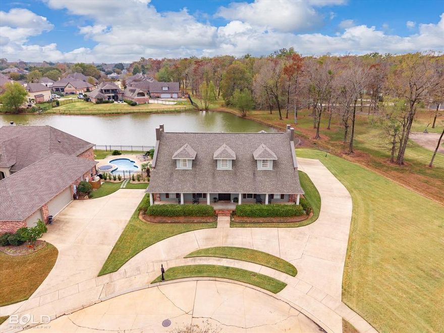 Magnificent, one of a kind home located in The Crossing at Carriage Oaks. Found at the end of a quiet cul-de-sac, with serene water views, this home perfectly blends stylish elegance with everyday comforts. From the well-manicured lawn to the impeccable interior design, you can see the care and quality put into every detail. Upon arriving, you are welcomed by an oversized front porch, made for rocking chairs and afternoon talks. As you walk through the front doors you are greeted by the beautiful entry way and bamboo floors; that is until the living room windows draw your attention to that backyard view. Walk a little further inside and you will see the stunning kitchen. Beautifully updated with an island big enough to fit the whole family as you cook and eat and catch up on life. This home provides 5 bedrooms and 5 bathrooms, including a downstairs Primary Suite and upstairs Primary Suite. The bathrooms have all been updated and are as beautifully designed as the kitchen. Upstairs, the oversized landing has so many potential uses. There is just so much great space to be considered. Once outside, you will find the covered back porch that overlooks the backyard and the pond that borders the property. Come out and see what makes this home so amazing.