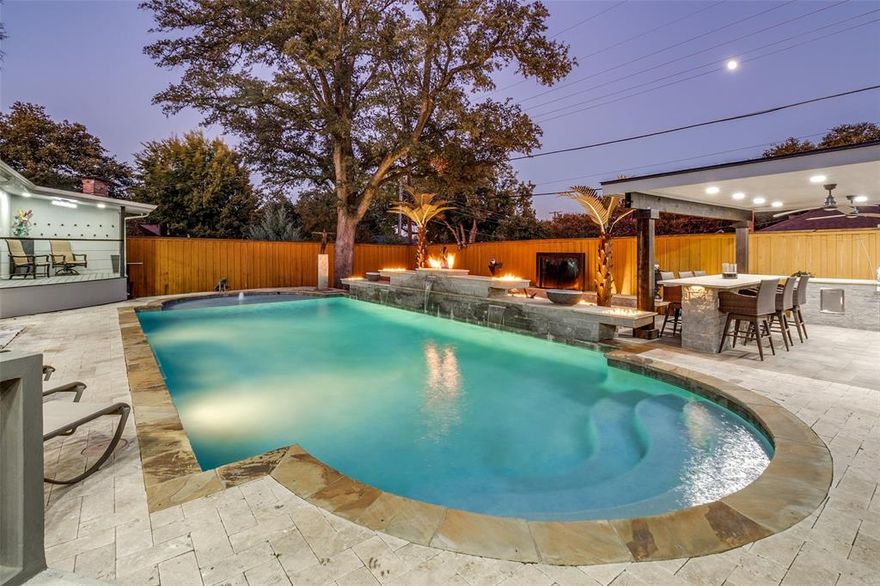 An owner's creative vision and the superior craftsmanship that saw that vision come to life are evident in this outstanding property! From the front door to the exquisite outdoor spaces, every surface has been upgraded with meticulous attention to detail. Over the past 5 years the owner has reimagined every space to maximize livability and function. Major systems were addressed as well with updated plumbing beneath the house and the majority of the sewer line was replaced along with the city sewer line. The metal roof (backed by a transferable lifetime warranty!) is a year old, tankless water heater was installed and additional insulation added to the attic. Designed for entertaining, the main living areas flow beautifully from the kitchen to the dining room and both living areas. Totally transformed, this huge island kitchen is a showstopper! Custom cabinetry makes the very best use of space and allows the stunning Quartzite finishes to standout next to an Aga convection-induction range with hood, Bosch dishwasher drawers and Jenn-Aire built- in fridge. Three bedrooms feature ensuite baths completely redesigned with leathered granite surfaces, bidet commodes, fixtures and stunning tile surrounds PLUS custom built-in closets for maximum storage! Bedroom 4 is a true flex space that works as a guest room-home office or exercise room with closets and cabinetry with access to the pool area. AND WHAT AN AREA! Magazine worthy with the addition of an outdoor kitchen and dining area, full bath cabana area, water and fire features, this outdoor living area was designed to extend the fun beyond the four walls! There are two heated and air conditioned units on the property that can be a studio, he-she cave, playhouse, office space, craft area or additional storage. Set on a .449 corner lot, close to great shops and dining with easy access to anywhere you want to go, this is the house you'll want to call home.
