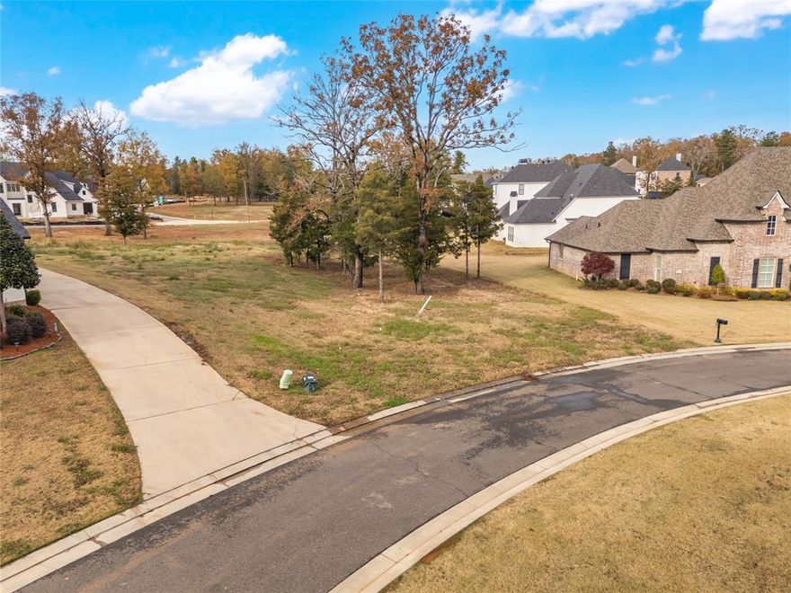 Come build your custom home in the highly sought after Southern Trace. Southern Trace Golf Course Community is a private gated neighborhood. The private member owned club offers 18 hole championship golf, tennis, pickle ball, fitness, swimming, dining, and so much more. There are so many family friendly activities throughout the year! This lot is located in a low traffic area and tucked away in the circle drive off whispering path. Whether you're an avid golfer or simply seeking an upscale environment this lot is for you!