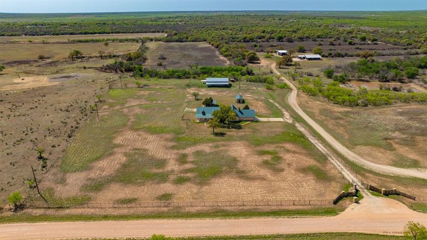 Sold As Is. Just north of Fort Phantom Hill Lake, this peaceful ranchette sits on over 6 fenced acres and offers great potential. From the moment you arrive at the gated entrance, you’ll notice the inviting covered porches with rustic cedar posts that give the property a warm, welcoming feel. The main home offers over 2,900 square feet with 4 bedrooms, 3 bathrooms, two fireplaces, and a split layout that gives everyone their own space. The primary suite features a sunken tub and marble floors, just waiting for your personal touch to turn it into a relaxing retreat. Out back, there’s a detached one bed, one bath efficiency apartment plus an additional storage building, giving you plenty of options for guests, hobbies, or extra income. You’ll also love the huge 2,400 square foot metal barn with cattle pens and fencing already in place, perfect if you’ve been dreaming of a small farm setup. This one needs a little TLC, but the opportunity here is hard to beat. If you’ve been looking for space, privacy, and the chance to make something your own, this could be it. Property is being sold as is, where is. Come take a look and imagine the possibilities!