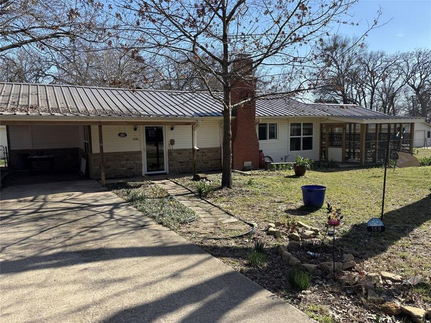 Charming 1-bedroom, 1-bath retreat nestled in a serene neighborhood with close access to the lake, perfect for peaceful living or a weekend getaway.
This cozy and inviting home offers a well-designed floor plan featuring 1 spacious bedroom and 1 full bathroom. The living area with the wood burning fireplace is bright and open, perfect for relaxing or entertaining.  An updated kitchen includes modern appliances and ample counter space with easy access to the dining area for making it easy to prepare meals while enjoying your company or views of the surrounding greenery.  Quartz countertops in both the kitchen and bathroom counters and walk in shower are stunning. The utility room has extra storage and plenty room for a freezer.  Fenced in backyard, open backdoor deck and an 8 x 10 storage building for the lawn tools and extra storage.  East maintenance vinyl siding and metal roof that is only 3 years old.