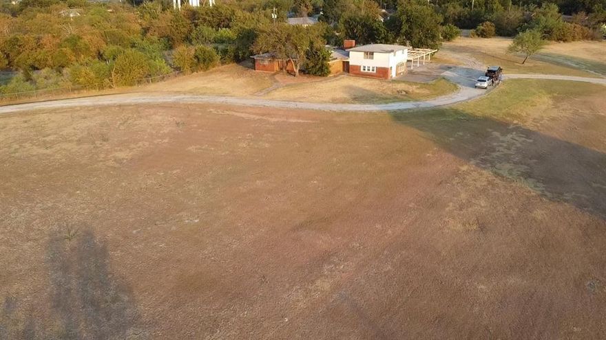 Are you looking for acreage in the city limits to build your dream home or an investment opportunity?  This 4.45 acre tract is the perfect plot for country living in town.  The house on site is most likely a total tear down which gives you the opportunity to make the place yours. City sewer, and water well. Survey is available.  Buyer will be responsible for fencing lot. Deed restrictions to include no mobile homes.