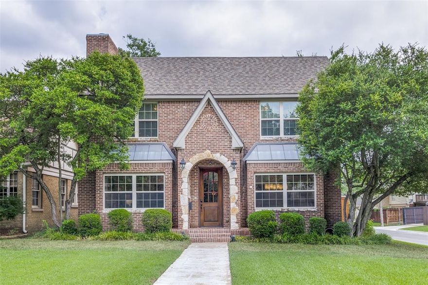Lower Greenville Ave CHARMER!!! Brought down to the studs in 2008, and then extensive renovations from 2019-2021, this classic M Streets Tudor has it all. Step through the charming brick arched doorway and discover a home where timeless elegance meets modern luxury. This stunning residence welcomes you with an open floor plan enhanced by transitional styling and beautiful 4-inch-wide hand-scraped hardwood floors flowing throughout the entire first level. The heart of this home is the gourmet kitchen, professionally remodeled in December 2019 with meticulous attention to detail. Quartz countertops, sophisticated marble backsplash, and premium stainless steel appliances create a chef's dream space. The oversized butler's pantry elevates your entertaining game with dedicated wine storage, built-in ice maker, and secondary refrigerator perfect for hosting gatherings of any size. Ascend to the 2nd level where 4 generously proportioned bedrooms await, complemented by a versatile sitting area ideal for a reading nook or home office. The primary suite features a romantic two-sided fireplace, private balcony for morning coffee or evening relaxation, and a custom wall unit installed in 2021 that provides both beauty and function. The thoughtful expansion added a practical 90-square-foot mudroom and an impressive outdoor kitchen, seamlessly extending your living space into the backyard. The lush corner lot is a rare find, offering a fenced side yard with ample room to add a sparkling pool. Modern conveniences include a sleek electric sliding gate and new garage door, both installed in October 2022. Tesla charging station was installed in 2023. Location completes this exceptional package. You'll enjoy tree-canopied sidewalks, walkable access to restaurants and boutiques, and easy connectivity to everything Dallas has to offer. Bonus home is zoned for award winning Mockingbird Elementary.