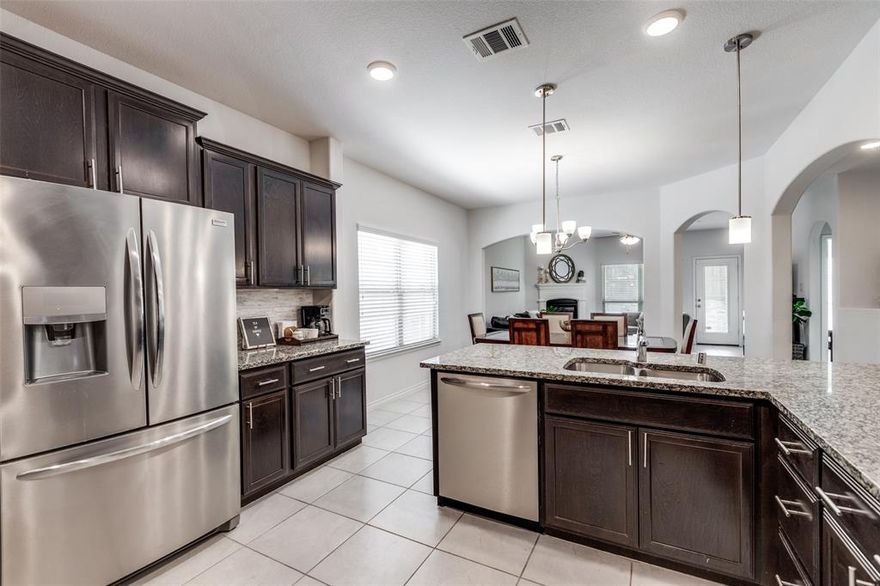 Welcome home to this beautifully designed north-facing residence, ideally positioned across from a wide-open green space that offers peaceful views and a sense of privacy. Located in a central McKinney location, this home provides easy access to the tollway, shopping, restaurants, and the popular PGA Headquarters.
Inside, soaring ceilings and a striking ceramic tile entry create an impressive first impression. The open floor plan seamlessly connects the main living spaces, making it ideal for both everyday living and entertaining. The spacious living area features a cozy gas fireplace and abundant natural light.
The kitchen is thoughtfully designed with stainless steel appliances, a double sink, generous breakfast bar, and a standout 5-burner gas range vented to the exterior, perfect for home chefs. The layout offers both functionality and an open connection to the living area.
The primary bedroom is located on the main level, providing a private retreat with comfort and convenience. Upstairs, there are 3 additional bedrooms, one currently being used as a office and can easily serve as a game room, media room or second living area.
Step outside to enjoy a roomy backyard with a nicely sized covered patio, perfect for relaxing or entertaining. The patio is wired for audio, creating an ideal setting for outdoor dining, gatherings, or quiet evenings at home.
Natural light flows throughout the home, enhancing the open and inviting feel. 
Adding to its appeal, the property is zoned to highly sought-after Prosper ISD, offering excellent educational opportunities while enjoying the convenience of McKinney living. Neighborhood amenities include a community clubhouse and resort-style pool area, perfect for social gatherings, relaxation.
With its desirable layout, impressive kitchen features, flexible living spaces, outdoor entertaining area, and prime location near major conveniences and entertainment, this home offers an exceptional North Texas lifestyle.