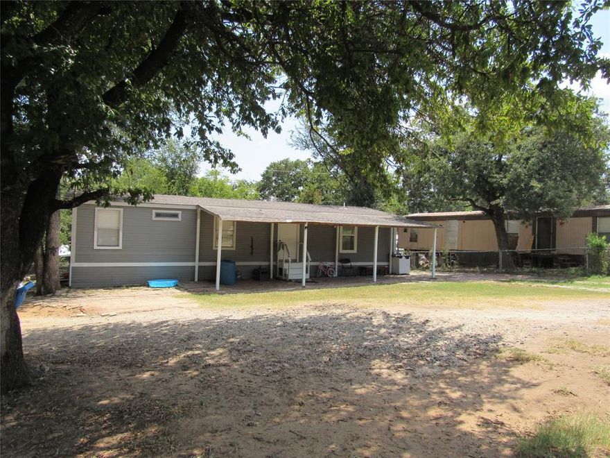 It is a great opportunity to own two side by side homes, live on one and rent the other or rent both for steady income. This well-kept 4 bedrooms 2 baths double-wide mobile home sits on approximately a quarter of an acre. Featuring an open concept designed ideal for everyday living. Its location is just off I-20 with quick commutes to Weatherford or Weatherford.