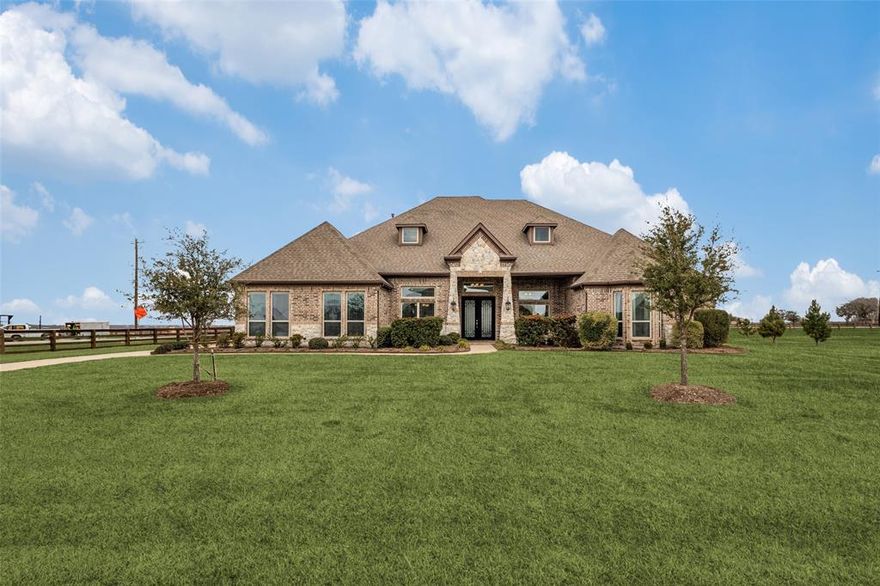 Owner relocation creates a rare opportunity to own this exceptional single-story estate priced below fair market value in the highly sought-after Argyle school district. Spanning over 4,300 square feet, this stunning brick & stone residence blends timeless elegance with modern comfort, offering a thoughtfully designed layout ideal for both everyday living & unforgettable entertaining. At the heart of the home, the gourmet kitchen is a true showstopper, featuring an oversized island, abundant storage, double convection ovens, & a spacious walk-in pantry, perfect for everything from casual meals to hosting on a grand scale. Set on a one-acre corner lot, the home offers 4 spacious bedrooms & 3.5 baths. Guests will appreciate a private bedroom with its own ensuite, while two additional bedrooms share a well-designed bath with dual dressing areas. A dedicated study with French doors provides versatility as a home office, gym, or creative space. Designed for gathering, the formal dining room sets the stage for special occasions, while the main living area offers warmth & comfort. Entertainment options abound with a dedicated media room with a projector and screen & an expansive game room—perfect for movie nights, recreation, or relaxing at home. The luxurious primary suite is a serene retreat, complete with a spa-inspired bath & a generous walk-in closet with island & built-in dresser. Step outside through glass doors to a covered patio featuring a cozy corner fireplace, an ideal space to unwind while enjoying peaceful views of a neighboring pasture with grazing horses & alpacas. Highlights include a tankless water heater, a 3-car garage, & charming split-rail fencing that enhances the property’s true estate feel. Combining generous scale, luxury amenities, & a premier location with convenient access to nearby shopping and dining, this home delivers refined country living at its finest. Opportunities like this are rare—schedule your private showing today before it’s gone.