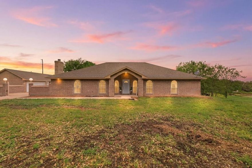 Enjoy a peaceful country fairytale on 5 acres where this beautifully maintained, custom-built 3-bed 3-bath home with 6-car garage awaits.

Step inside this 2,674 sq ft of light-filled living, where soaring 10-foot ceilings and an open, flowing design create a space that feels both grand and inviting. The heart of the home is warmed by a cozy wood-burning fireplace with a gas starter—perfect for quiet evenings as golden light dances through each arched window across the huge room. The kitchen is a charming gathering place, thoughtfully designed with an island, double built-in ovens, ample cabinetry, and tile countertops. A large window draws your gaze outward, where sweeping views of the land unfold like a storybook scene, bringing a sense of calm and wonder to everyday moments. Just beyond the kitchen, an oversized laundry room offers effortless convenience.
This home has an abundance of cabinetry & closet space ensuring everything has its place.

The private primary suite feels like a retreat: complete with custom drapes, a mini-split system, and a spacious bath with dual sinks, a jacuzzi tub, separate shower, and walk-in closet. Two additional bedrooms offer flexibility, including one with a private bath and another tucked away for guests or a quiet office.

Beyond the home, the story continues with a climate-controlled workshop, abundant storage, and a security system. The well house offers a 2023 pump, water filtration system, and emergency diesel generator with manual transfer switch, along with a 500-gallon propane tank (2026).

Outdoors, mature oak & native trees frame a landscape of beauty & possibility—featuring a large red barn, two ponds, and a private creek. With open space for horses, livestock, or quiet wandering, this property feels like a storybook escape brought to life.   
Buyer & Buyer’s Agent to verify all info, including but not limited to sq ft, schools, taxes, restrictions, utilities. See deed restrictions uploaded.
