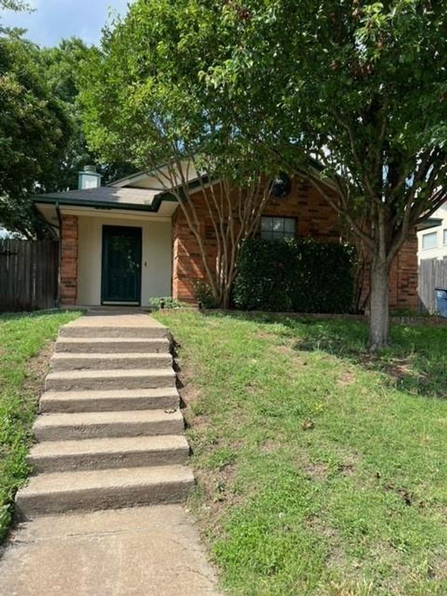 Highly sought after Keller ISD. This home features an open-concept living and kitchen area with vaulted ceilings, a cozy woodburning fireplace, plant ledges, and a breakfast bar. Recent updates include fresh paint and wood-look LVP flooring. Enjoy the convenience of a rear entry garage and being within walking distance to Bluebonnet Elementary. Low maintenance yard. A perfect fixer upper opportunity, ready for your personal touch and imagination to bring out its full potential. Buyer and buyer agent to verify all information. Please, no blind offers, view property before submitting offer. No owner financing available.