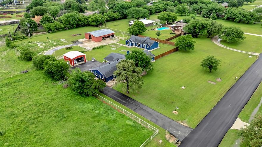 Discover a rare opportunity offering flexibility, INCOME potential, and room to grow in a desirable Keller location. Situated in an unincorporated area, with TWO residences, this property allows for commercial use, up to five outbuildings, and the benefit of lower taxes, making it ideal for business owners, multi generational living, or those seeking space without restrictions. Inside the main house, the thoughtfully designed kitchen is a chef’s dream with granite countertops, a gas cooktop with vent exhaust, double ovens, a wine rack, and a spacious butler’s pantry large enough to accommodate a second refrigerator. The kitchen opens seamlessly to a stunning floor to ceiling brick, wood burning fireplace that anchors the living area with warmth and character. The flexible floorplan includes a large flex space ideal for a home office, workspace, or additional living area. The primary suite is designed for comfort and function, featuring separate his and hers closets, a Hollywood bath with dual vanities, and a walk in shower. Outdoors, the property continues to impress with a 40'x50' barn with 3 stalls for horses, 8in concrete floors and peaks at 15' and a stable that includes a built in workshop, offering endless possibilities for hobbies, storage, or business use. One of the standout features is the second home finished in 2022, a well appointed 3 bedroom, 2 bathroom residence and approximately 1,500 square feet, complete with a large covered patio, making it perfect for guests, rental income, or a private office setup. The main home also offers a detached 2 car garage and its own expansive covered patio, creating multiple spaces to relax and entertain. *Owner financing is available* With room to expand, work, and live the lifestyle you want, this one of a kind property delivers versatility that is hard to find and is ready for its next owner now. Call today for more information!