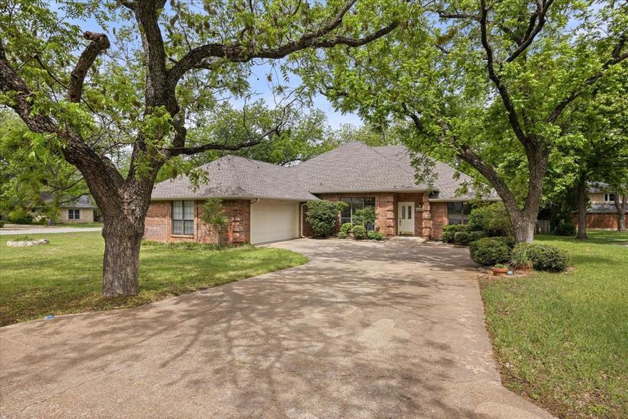 This updated 4-bedroom, 2-bath home offers 2,300 square feet of comfortable, easy living in the highly sought-after community of Pecan Plantation. With a split floor plan, the layout gives the primary suite its own space while still keeping everything else connected and functional. You’ll find two living areas and two dining spaces, giving you plenty of flexibility whether you’re hosting or just spreading out.

The kitchen has a clean, modern feel and flows nicely into the main living areas. Fresh paint and updated flooring throughout make the home feel move-in ready, and the French doors along the back bring in tons of natural light. You’ll also notice the detailed crown molding and trim work that add a polished, custom touch without feeling overdone.

The primary bedroom is generously sized and set apart from the other bedrooms for privacy. The ensuite bath includes dual sinks, a jetted garden tub, separate glass shower, and a large walk-in closet. On the practical side, there’s a spacious laundry room with extra storage and a 2.5-car garage complete with a workbench and a separate golf cart entrance.

Outside, the covered back porch is a great spot to unwind or entertain, overlooking a corner lot with mature trees and low-maintenance landscaping. Located on a quiet circle, the setting feels peaceful while still being part of an active, amenity-rich neighborhood.

Living in Pecan Plantation means access to golf, marina, parks, trails, and more—all within a gated community with 24-hour security. It’s a great mix of affordability, comfort, convenience, and lifestyle.