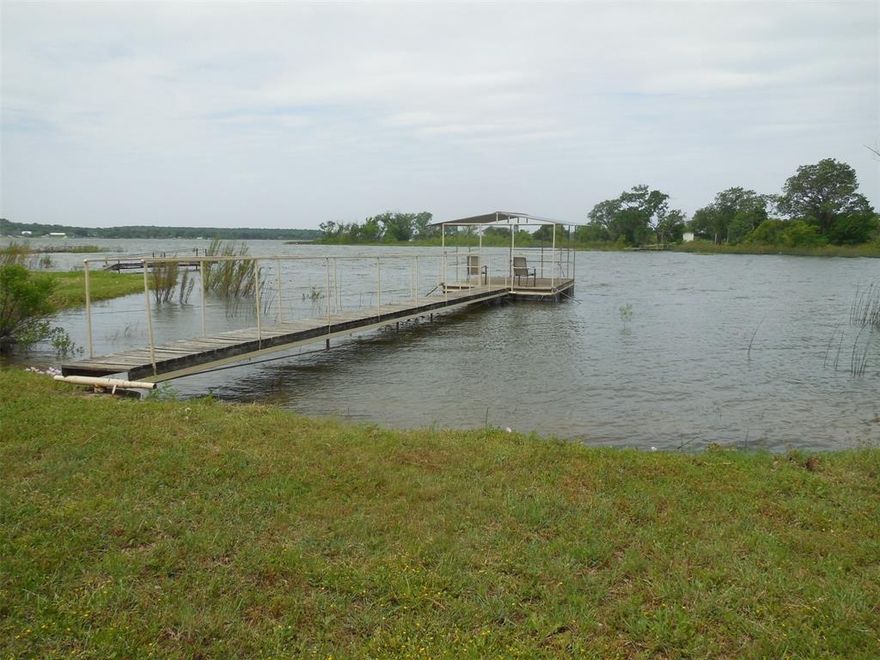 Quiet wooded Lake Leon waterfront lot with a 3 bedroom, 1 bath home. Larger living area with a wood stove, dining area and a large window looking out to the lake. The kitchen also has a dining area. The primary bedroom has a deck with a view to the lake. There is a patio, container for storage, and a covered fishing dock. Nice, shaded backyard for your entertaining needs. This is located on a quiet waterfront location but just around the bend to the main body for your water recreation activities. Call today for your personal tour and just in time for the summer activities to begin!