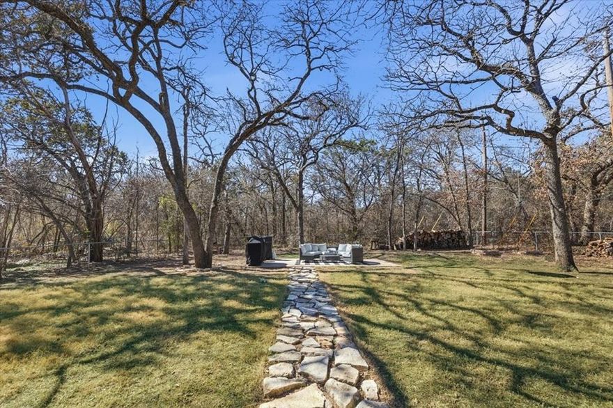 Welcome home to your own little paradise in the heart of Granbury.  Nestled in the back of the highly sought-after Spanish Trail neighborhood, this hidden gem offers the perfect blend of privacy, comfort, and small-town charm. With very little traffic in this quiet section of the community and heavily wooded lots on both sides, you’ll enjoy a peaceful, secluded setting that truly feels like a retreat.  This inviting 3-bedroom, 2-bath home features a flexible bonus room thoughtfully built out in the garage — ideal for a second living area, kids’ game room, home office, or media space. Whether you're hosting family movie nights or giving the kids their own hangout spot, this extra space adds versatility to fit your lifestyle.  Living in Granbury means embracing a high quality of life with the warmth of a close-knit community. Known for its small-town charm and the beauty of Lake Granbury, the area offers outdoor recreation, historic downtown shopping, and year-round events — all while enjoying more affordable living and lower property taxes than many surrounding areas. And when you’re ready for big-city amenities, Fort Worth is just a convenient drive away.  If you’ve been looking for privacy, community, and comfort all in one place, this Spanish Trail treasure is ready to welcome you home.