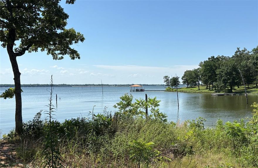 WATERFRONT on Lake Fork! Your opportunity to own 2 waterfront lots on World Famous Lake Fork with nearly 1 acre of additional SRA leaseback. These lot has some beautiful trees and views of the lake and plenty of privacy as these lots are located at the back of gated community. This is a ready to enjoy package with 36' camper (sleeps 8) and nice RV canopy already in place. These lots have a circle drive for plenty of truck and boat parking. This location is on a cul-de-sac for minimal traffic and noise. This private gated community allows RV living, clubhouse, restaurant, pool, picnic areas, community boat ramps, high speed internet available, trash service and more. Come enjoy the beautiful sunset and views at your very own getaway. These lake front lots don't come available very often and YES the RV is included.