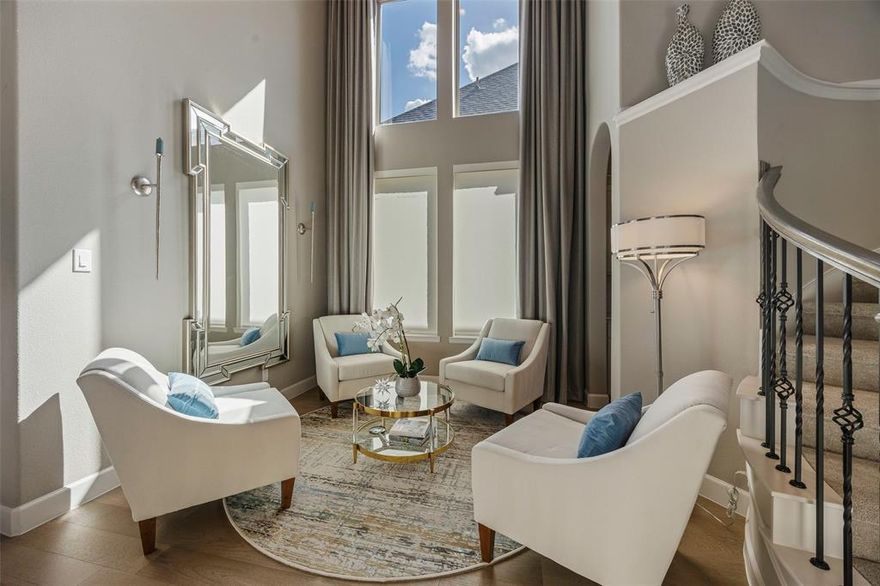 Step into this pristine Britton Homes masterpiece, built in 2021 and meticulously maintained to feel better than new. A grand two-story foyer with soaring 21-foot ceilings makes an unforgettable first impression, while rich wood floors guide you through the private study with French doors, elegant conversational room, and the open-concept living spaces beyond. The chef’s kitchen steals the spotlight with a butler’s pantry and seamless flow into the dramatic family room with high ceilings complete with a striking corner fireplace and expansive sliding glass doors that creates natural light. The  secluded primary suite is a true sanctuary, showcasing a wall of windows and a spa-worthy bathroom featuring dual vanities, a soaking tub, glass-enclosed shower, and two walk-in closets. Upstairs, a spacious game room and well-appointed secondary bedrooms offer room for everyone to unwind.
Outside, a covered patio invites easy outdoor living with privacy screens and the three-car garage provides plenty of space for vehicles, storage, and weekend toys. This home blends luxury, comfort, and thoughtful design at every turn.  What are you waiting for?