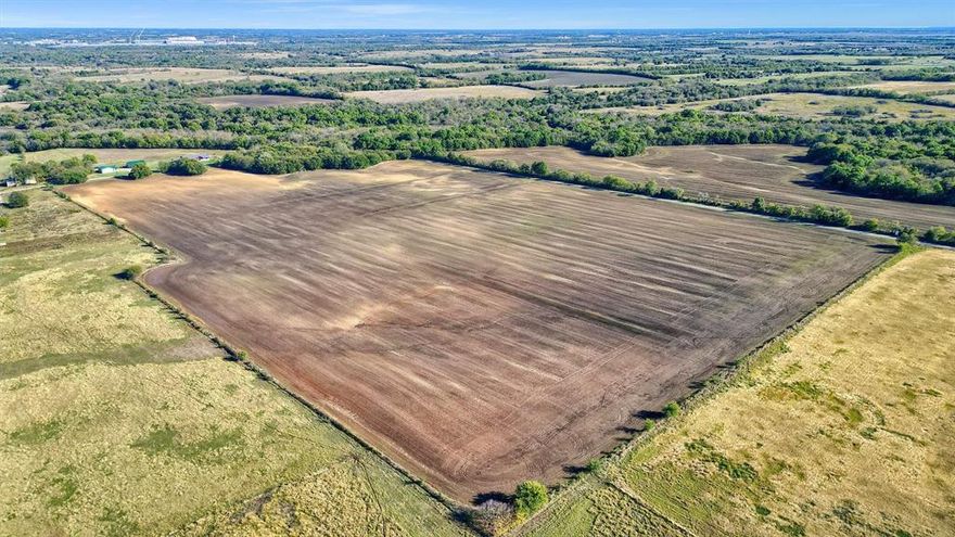 nice level cropland with paved road on two sides. Great site foe future use or excellent to subdivide for rural residential. Two  Dorchester water meters on site.