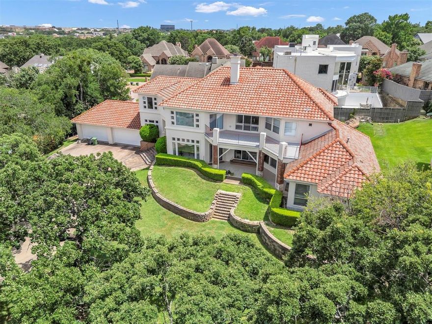 BACK ON MARKET FROM BUYER DEFAULT - REDUCED for quick sale!  So much potential and space to improve upon.  Mediterranean Elegance Meets Modern Comfort.  Perched gracefully atop a hill in Arlington, Texas, this one-of-a-kind custom-designed  Ken Schaumberg home is a masterclass in Mediterranean-inspired luxury. With breathtaking views and an elevated presence, this residence blends timeless architectural beauty with modern functionality. Step inside to a stunning open-concept layout where warmth and elegance flow seamlessly through every room. The interior showcases a calming neutral color palette that highlights the home’s spaciousness while inviting your personal style to shine. Designed for everyday comfort and entertaining, this home features four expansive bedrooms, each with its own full en-suite bathroom and walk-in closets, offering ultimate privacy and convenience.  Coziness abounds with three perfectly appointed fireplaces, strategically placed to create ambiance and charm throughout the home. Enjoy the flexibility of an open concept kitchen with generous cabinetry, designed to maximize both space and functionality.  You will notice the kitchen leads to the butler's pantry which also allows for access to the second outdoor kitchen located within a screened-in patio.  Every inch of this home is thoughtfully crafted, from the generous living areas to the peaceful retreats of each bedroom. Natural light pours through large windows, enhancing the bright, airy feel that makes this home both inviting and inspiring. 

Ideally located just minutes from DFW International Airport, Six Flags Over Texas, ATT Stadium and all the entertainment, shopping, and dining Arlington has to offer, this home combines serene living with unbeatable access. Although this beautiful home is being offered AS-IS, the home is well maintained, structurally sound, roof is in good condition with no leaks and no foundation issues.  Seller will consider all reasonable offers.