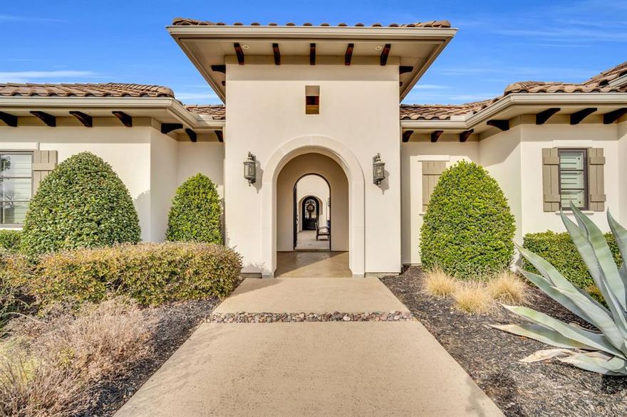 Exquisite single-level estate nestled inside the private, gated enclave of Chateau Du Lac’s most exclusive section, The Enclave. This custom-built residence offers a rare luxury living, designed with an open-seamless layout that blends sophistication and comfort. From the moment you arrive, the home impresses with its elegant courtyard entry featuring a cozy fireplace, a perfect setting for entertaining! The chef’s kitchen is both striking and functional, anchored by a 6-burner gas range, built-in refrigerator, oversized island, granite surfaces, and custom 42in cabinetry, ideal for entertaining on any scale. Every bedroom is a private en-suite, ensuring privacy for family and guests alike, while the owner’s retreat feels like a five-star spa with a soaking tub, frameless walk-in shower, dual granite vanities, and a custom-designed closet. A separate fifth bedroom with its own entrance offers an exceptional guest or in-law suite option, and the media room is pre-wired for 7.1 surround sound for an immersive experience. Outdoor living is equally impressive with multiple covered patios, an outdoor kitchen, and a spacious backyard that invites endless possibilities. High-end finishes throughout include hand-scraped hardwood floors, crown molding, 8’ solid-core doors, elegant baseboards, and a stunning cast-stone fireplace. Recent updates such as freshly painted stucco, recent driveway finish, and epoxy-coated garage floors. Energy-conscious features like a tankless water heater, radiant barrier roof decking, Low-E3 windows, a 16-SEER HVAC system, and a pre-wired security system provide peace of mind and efficiency. Professionally landscaped grounds framed by wrought iron fencing and accented by cedar garage doors complete this move-in ready estate. Truly a rare opportunity to own a luxury single-story home in one of Flower Mound’s most prestigious communities. Across the street the street from a catch-and-release pond for fishing enthusiast.