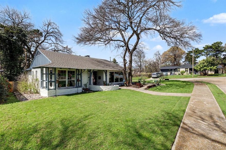 Stunning charming sprawling gem on large corner lot in hidden jewel area adjacent to Beckley Club and not far from Bishop Arts District! Fabulous gorgeous property for lovely living, entertaining, etc. Very large Xeriscaped rear yard with privacy fence, and recently installed spacious '24x'24 deck area. Recent new roof! Recent paintwork. Recent highly durable LVP flooring in the den, dining room, and bedrooms. Large format polished porcelain tile flooring in the kitchen and office. Welcoming formal entry foyer with sidelights and vintage concrete tilework which is matched in rear hallway. Beautiful tinted framed windows bathe the updated kitchen, dining room, and office area in soft natural light. Wonderful spacious den for relaxing times features a beautiful brick fireplace and wood beamed ceiling. Kitchen for serious cooking with gas range, pot filler, stone countertops, farmhouse sink, recently new cabinetry, soft-close drawers, eat-in bar area. Large pantry and storage room off the kitchen with separate exterior door for convenience. Two updated full bathrooms, primary has blue pearl granite flooring, secondary has absolute black granite flooring. This is a must see property. Real Peacocks are part of the scenery of this eclectic area. Chandelier in dining room is excluded but negotiable.