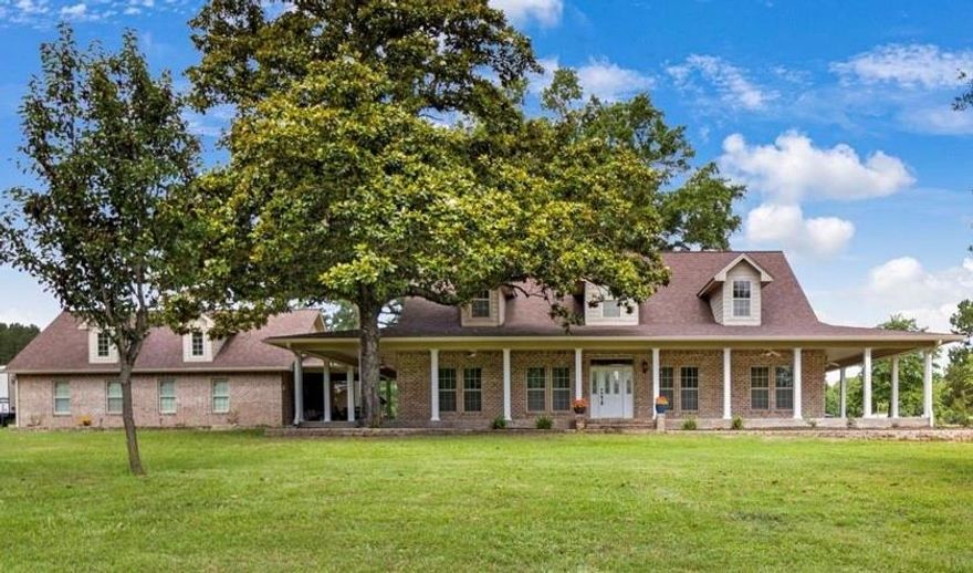 If you’ve been dreaming of space, privacy, and the kind of peace only East Texas can offer, this property delivers.
Set on 27 beautiful acres just minutes from Gilmer and Pittsburg, this 4-bedroom, 3-bath home welcomes you with a tree-lined driveway, open views, and the quiet of nature, complete with a creek and abundant wildlife.

Inside, the layout is both functional and inviting. The open-concept main living area is ideal for everyday living and gathering, while the split floor plan offers privacy for the primary suite. Upstairs, a large bonus room with its own full bath adds incredible flexibility, perfect for a guest suite, game room, home office, or second living space.

A full-length sunroom stretches across the back of the home, creating a peaceful place to enjoy the land year-round, and the wrap-around porch is made for morning coffee, evening sunsets, and slow East Texas days.

Outside, the property truly shines with a detached garage, a large workshop with additional rooms, and plenty of space for equipment, hobbies, animals, or weekend projects. Thoughtful upgrades include paid-off solar panels at closing and a whole-house Generac generator, offering energy savings, reliability, and peace of mind.

Homes with this much land, versatility, and efficiency are rare. Come experience the space, freedom, and lifestyle waiting for you!