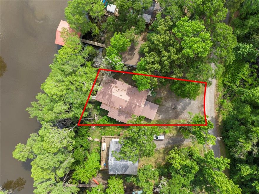 Welcome to the Lakehouse on Big Cypress River on Caddo Lake! This one-of-a-kind location is considered the best spot on the river, offering breathtaking views and unparalleled tranquility. Sit back and relax on the catwalk as you watch boats cruise along the river, all while enjoying the peacefulness of your private cove. 

Inside you will enter to an open concept living, dining room and kitchen with gorgeous views of the river. The large Primary Bedroom is a true retreat, with beautiful Cedar Plank Walls, a spacious bathroom featuring a Jacuzzi Garden Tub for ultimate relaxation, and a Huge Walk-in Closet. The Second Bedroom is fresh and inviting, while the Third Bedroom is newly remodeled offering a great space as a guestroom, office or kid’s game room. 

Step outside and prepare to be amazed! The wrap-around porch and deck areas provide breathtaking views of the river, creating a serene setting perfect for both relaxation and entertaining. For fishing enthusiasts, this is truly a paradise. Imagine casting your line and reeling in the catch of the day, just steps away from your own backyard or swimming off the dock.  The boathouse below deck is conveniently attached to the dock by plank walkways, offering easy access for all your water activities. 

But the features don't end there! This home also includes a spacious workshop located under the house, providing ample space for boat storage, golf cart parking, and more. Other notable features include a fenced yard, RV hook-up, and covered parking. 

By water, it is centrally positioned on Big Cypress Bayou, nestled in at Mossy Break and Clintons Chute near Cypress Village. Sesame Street boasts peacefulness and tranquility, with no through traffic. You are a quick five minute drive by boat to Big Pines Lodge, 20 minutes to Jefferson or 40 minutes to the casinos in Shreveport - incredible!

This home has never flooded, providing peace of mind for you and your family. Welcome to your dream riverfront retreat!