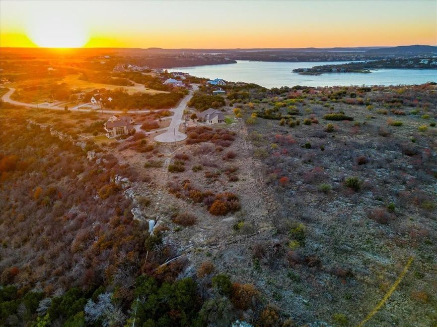 Welcome to one of the most coveted addresses in The Cliffs Resort on Possum Kingdom Lake. This lot is a rare opportunity in Phase 1, where concrete streets and established surroundings set the tone for enduring value and refined lake living. Perched above the Brazos River Valley, this homesite offers a sweeping unobstructed view that feels both expansive and peaceful. If sunrises speak to your soul, this is your front row seat! Each morning unfolds with soft light spilling across the valley, creating a daily moment of calm and inspiration. Bay Hill is known for its prestige, elevation, and views; which make it one of the most desirable streets in the resort. Whether you envision a weekend retreat or a full time residence, this lot provides the perfect canvas for a custom home designed to capture the scenery, the light, and the lifestyle. Ownership in the Cliffs means more than just land. It is access to championship golf, lake privileges, gated security, and a community that blends luxury with laidback Texas charm.
You've been waiting for the right lot in the right location with a view that truly stops you in your tracks and THIS IS IT!