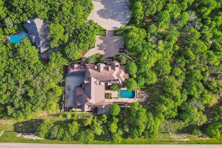 BELOW MARKET PRICE for opulent Manor nestled in prestigious gated neighborhood on tranquil cul-de-sac offering unparalleled 4-acre privacy.  Massive scaled estate boasts three floors, 5 ensuite bedrooms, 4 half baths plus separate one-bedroom multi-generational suite with its own kitchen, laundry room and west facing patio to enjoy stunning sunsets.  This European style estate is crafted with the utmost attention to detail and quality.  Two-story ceilings, chandeliers and oversized closets throughout; oversized chef’s kitchen, 5 imported stone fireplaces; wine room, media room with bar, butler service by dining room, huge laundry room and third-floor gym, RARE 6-car garage with workshop, storage cabinets and more closets!  Four sets of stairs and elevator.  Enjoy resort-style living with a lavish pool and expansive outdoor kitchen, living area and fireplace.