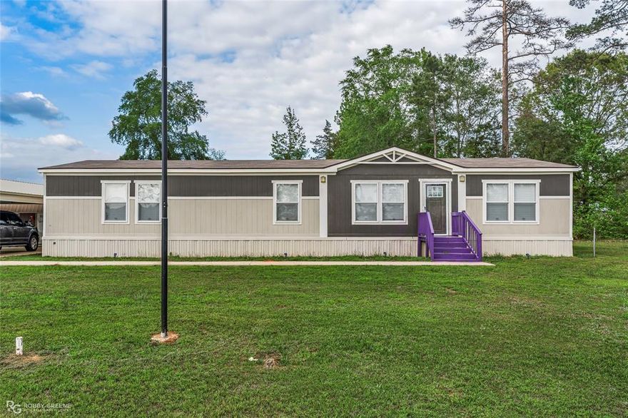 Welcome to this spacious 4 bedroom, 2 bath manufactured home nestled on 1.421 acres in Benton! This thoughtfully designed home features two separate living areas, giving your family the flexibility to relax, entertain, and have personal space all under one roof. The generous eat-in kitchen is a true gathering spot, offering ample room for a full dining set and the kind of casual family meals that make a house feel like home. The outdoor amenities are where this property truly shines. A large concrete covered parking area comfortably fits multiple vehicles as well as an separate covered parking for your RV, no more searching for off-site storage. The dedicated workshop is ready for your projects, and several sheds round out the storage options, keeping everything organized and protected from the elements. Spread across more than an acre, you'll have the privacy and outdoor space to garden, play, or simply enjoy Louisiana's beautiful evenings on your own land. Whether you're upsizing, looking for room for extended family, or just craving more land and storage than a traditional subdivision can offer, this home delivers. Conveniently located in Benton with easy access to schools, shopping, and Bossier City. Call today to schedule your showing!
