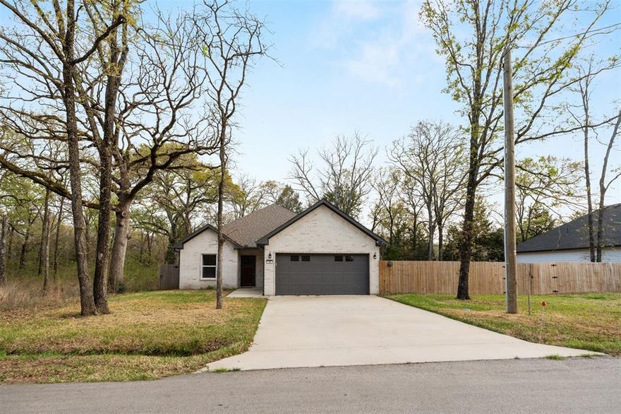 Newly built 3-bedroom, 2-bath home featuring a desirable split floor plan and open-concept design in a quiet neighborhood at Cedar Creek Lake. The spacious living area flows into the kitchen and dining space, creating a comfortable layout for everyday living and entertaining. Tile flooring throughout the main areas adds both style and easy maintenance.

The primary suite offers a relaxing retreat with dual sinks, a separate tub and shower, and a walk-in closet. Two additional bedrooms are located on the opposite side of the home, providing privacy for family or guests. Additional features include a separate utility room, 2-car garage, and a covered back patio perfect for enjoying the outdoors.

An adjacent fenced lot is available for purchase, offering the option to have a larger fenced backyard. Residents enjoy access to a nearby HOA park and boat ramp, making it easy to enjoy Cedar Creek Lake. Low HOA dues add to the appeal of this peaceful lake-area neighborhood.