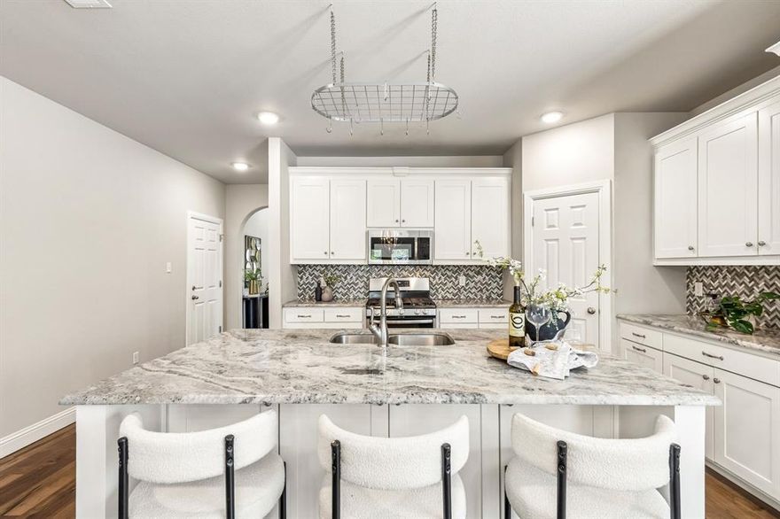 Welcome to this beautifully maintained and thoughtfully designed home offering a seamless blend of comfort, style, and functionality. From the moment you arrive, you’ll appreciate the charming curb appeal, mature landscaping, and inviting front covered porch. Inside, an open-concept layout is highlighted by rich wood flooring, abundant natural light, and a neutral, modern palette. The spacious living area centers around a cozy fireplace and flows effortlessly into the dining space and chef-inspired kitchen, complete with a large island, stainless steel appliances, gas cooktop, ample cabinetry, and a stylish backsplash—perfect for both everyday living and entertaining. The private primary suite is a true retreat, featuring a tray ceiling, generous proportions, and a spa-like ensuite bath with dual vanities, a soaking tub, and a deep walk-in frameless shower designed for relaxation. Secondary bedrooms are well-sized and versatile, offering comfortable accommodations for family or guests. Secondary bathroom is finished with granite countertops, dual sinks, clean tile work, and a light, airy feel that carries throughout the home. Fourth bedroom is wonderful option for office or flex space providing the ideal work-from-home setup or optional second living area, adding to the home’s overall flexibility. Step outside to enjoy a well-sized backyard, with landscape turf, to play or entertain. Ideally located with convenient access to Downtown Roanoke, and with quick access to I-114, this area is known for its vibrant dining and entertainment scene, as well as nearby shopping. Zoned to Northwest ISD. BRAND NEW CARPET.