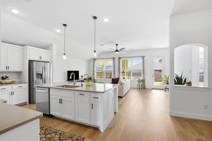 Immaculately maintained and move-in ready, this 2022 single-story home is located in the sought-after Marine Creek Ranch community. The open, light-filled floor plan features refined finishes and effortless flow from the spacious living area into a chef-inspired kitchen complete with a large island, gas cooktop, walk-in pantry, and elegant eat-in dining space. The private primary suite is filled with natural light and offers a spa-like retreat with a garden tub, beautifully designed shower, separate vanities, and an expansive walk-in closet with custom built-in cabinetry, all ensuite to the bedroom. A third bedroom offers flexibility as a home office, fitness room, or additional living space. Neutral, sophisticated tones enhance the home’s modern aesthetic throughout. The covered back patio extends the living space outdoors, while the privacy-fenced backyard is ready to be tailored to your lifestyle. A two-car garage with interior access completes the home. Marine Creek Ranch offers sidewalks and scenic jogging and biking paths, along with convenient access to shopping, dining, major highways, and Eagle Mountain-Saginaw ISD.