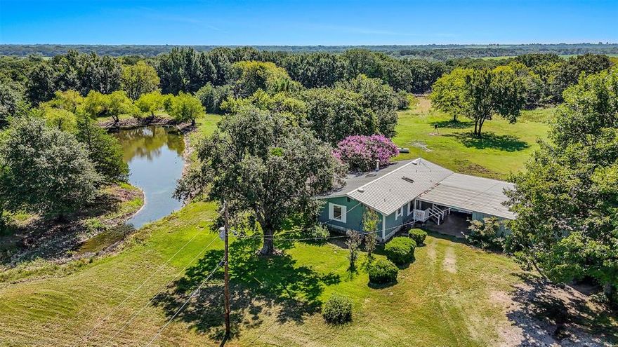 Discover this one-of-a-kind 42-acre private ranch estate adjacent to Terrell City Lake offering natural beauty, and endless possibilities.  A sunroom was added with a wall heater and window unit, which brings the square footage to approximately 1600 sqft.  Nestled on rolling terrain and set far back from the road behind a gated entrance, this private property provides the perfect escape from city life while still being conveniently located near Terrell. The charming 2-bedroom, 2-bath home sits in a prime location on the property, offering peaceful views of the pond and scattered mature oaks that create a serene, park-like setting. A seasonal creek runs along the property, adding to the tranquil, natural ambiance.  Ideal for outdoor enthusiasts or those seeking a private homestead, the land is currently exempt for agriculture and wildlife management, attracting deer and native wildlife—perfect for observing or recreational use.  Outbuildings include a workshop with concrete floor, electricity and water.  A barn previously used to raise Emu's features water lines in the concrete with the ability for the floor to once again be heated...perfect for chickens or animals.  Additional features include: Three ponds, a nice storm cellar, large covered carport, gated entry and gently rolling terrain with multiple ideal homesites.  Whether you’re looking for a weekend retreat,  future dream homesite, or land to invest in, this rare opportunity is priced to sell. Don't miss your chance to own a slice of Texas countryside that’s both scenic and functional.