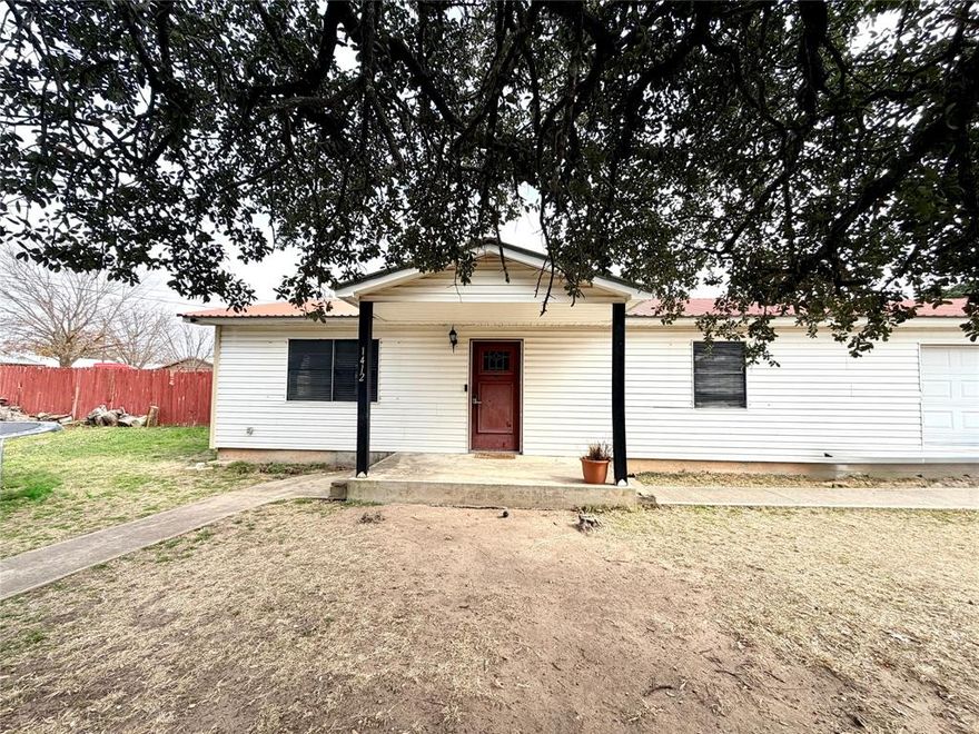 Welcome home to this well maintained 2 bedroom 1 bath property located on a corner lot in Goldthwaite Texas. A gorgeous oversized live oak tree provides excellent shade and strong curb appeal, creating a welcoming first impression. Inside, the home offers spacious rooms and central heat and air for year round comfort. The bathroom is thoughtfully designed with both a separate soaking tub and walk in shower, a feature not often found at this price point.

Additional highlights include a durable metal roof and a very large attached two car garage with ample space for parking, storage, or a workshop. The fenced backyard includes a small storage building, ideal for tools or lawn equipment. Whether you are a first time homebuyer, looking to downsize, or searching for a solid investment property, this home offers comfort, functionality, and classic small town charm.