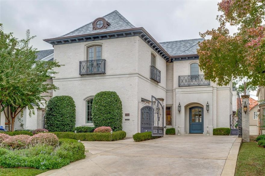 Sophisticated, curated and located just two blocks from Highland Park Village, this home offers a tranquil retreat near fine dining, shopping and schools. Originally built and created with pride in every detail of its design and construction to create a timeless home. The gated driveway with gas lanterns, copper gutters, fountains, and bevel leaded glass windows highlight the incredible architecture. The foyer features crystal chandeliers and custom marble which leads to the living area with hardwoods and barreled ceilings. Open kitchen features marble island, and Wolf appliances. Master suite is on 1st floor with stone fireplace and French doors opening to the courtyard. 2nd floor includes media room, 2nd master suite, and two more bedrooms, one currently being used as the office. Outside is courtyard with fireplace. The current owner used Pulp Design Studios to elevate it to the warm, cozy and modern conveniences, such as remote access to all media, temperatures, lighting and gates.