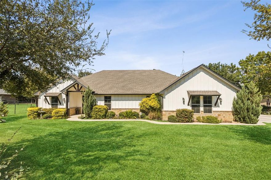 This beautifully maintained home combines comfort, efficiency, and stunning outdoor living spaces. Step inside to a welcoming family room accented with striking wood beams and a cozy wood-burning fireplace, creating the perfect spot to gather. The office-den features a custom ceiling design, while the open floor plan allows the kitchen to flow seamlessly into the family room, making entertaining a breeze. Energy efficiency is a standout feature, with an encapsulated attic and additional insulation that keeping utility bills surprisingly low. Wood blinds throughout, full gutters, and thoughtful updates add both style and practicality. Outside, the property truly shines with tranquil views from every angle. Enjoy extended decking, lush landscaping, a dry stream bed with river rock, and a fully fenced yard with an electronic gate for privacy and security. The spacious yard invites wildlife from cardinals and hummingbirds to playful bunnies bringing nature to your doorstep. A 12 x 20 metal building with an 8’ covered porch (currently used as a gym) and an additional storage shed provide endless versatility. The oversized covered porches allow you to relax outdoors rain or shine, where sunsets off the back porch are a daily delight.With 11-zone sprinklers, thoughtful upgrades, and peaceful surroundings, this home offers a rare blend of comfort, efficiency, and outdoor living.