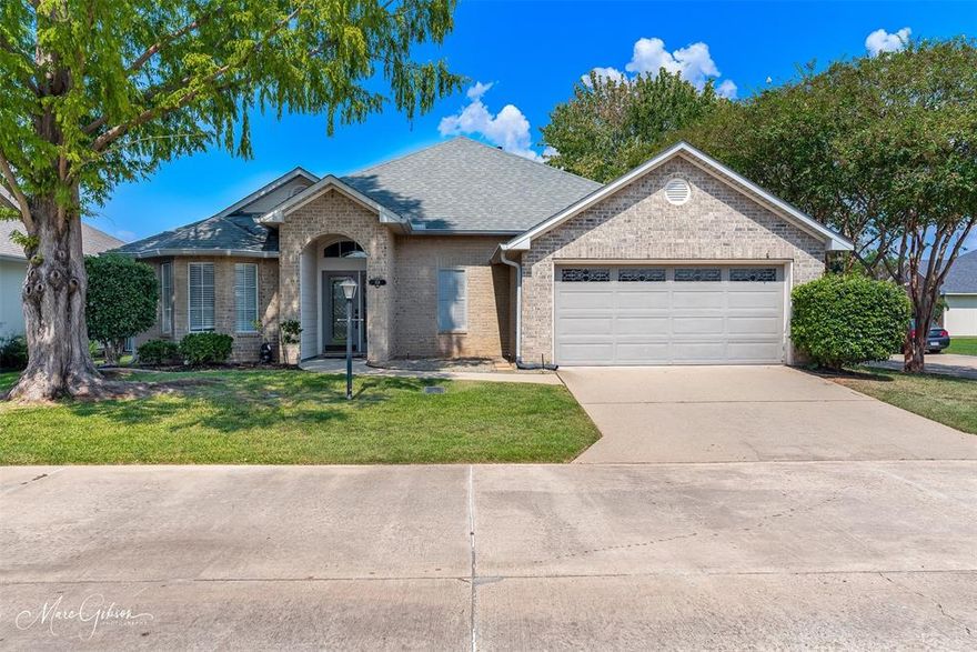 Custom, one owner home with 3 bedrooms and 2 bathrooms, located on a corner lot in a gated community of King's Pointe. The foyer features a beautiful door with window above for natural light and leads to a separate dining room with bay window that can also serve as an office or additional sitting area. The open floor plan includes a large living area offers fireplace, windows with views of back yard and door for direct patio access. Kitchen offers  black appliances, refrigerator remains and breakfast area with two decorative niches. Flooring is a unique ceramic tile and beautiful hardwood throughout. The remote master suite provides privacy with a double vanity and large walk in closet. The fully fenced backyard has a pond. The garage is finished with an epoxy floor and includes a heated and cooled storage room. The HOA maintains the front lawn. Conveniently located near shopping, dining, and medical facilities, and LSUS.