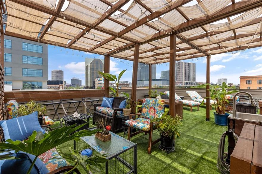 Are you a sports enthusiast? FIFA is coming!! Welcome to the ultimate LIVE, WORK, PLAY dream home in the heart of East Quarter, Downtown Dallas! Steps from the Dallas Farmers Market, incredible restaurants, and entertainment, minutes from Deep Ellum, the AA Center, West End, and Uptown, this home offers unbeatable access to everything that makes Dallas vibrant. With easy highway access and a location designed for those who thrive in the city's energy, this is your chance to own a piece of one of the hottest neighborhoods in town. 
This three-story brownstone townhome is the perfect blend of modern sophistication and urban convenience, offering 2,455 square feet of thoughtfully designed living space. With two spacious bedrooms, a versatile flex room, and two and a half baths, this home delivers the perfect balance of style, function, and flexibility.
Step inside to an open-concept second level, where the living room, dining area, and chef’s kitchen flow seamlessly together. High-end finishes, granite countertops, a gas cooktop, custom lighting, and an oversized island make this space perfect for entertaining. The primary suite spans the entire third floor, featuring a private sitting area, an ensuite bath with dual sinks, a soaking tub, a separate shower, and a massive walk-in closet. The first level offers a guest suite with a full bath. The second floor has a corner room flex space that can serve as an office, workout area, or extra bedroom, complete with a a view of the East Quarter Red Bear!
One of the home’s most incredible features is the furnished 800-square-foot rooftop deck with breathtaking city views, offering the perfect backdrop for relaxing evenings or weekend gatherings. And yes—the rooftop furniture stays! Other bonuses include a two-car attached garage on a private street - plus 1 street parking at the front door, low HOA fees, and short-term rental-friendly policies, making this an excellent opportunity for homeowners and investors alike.