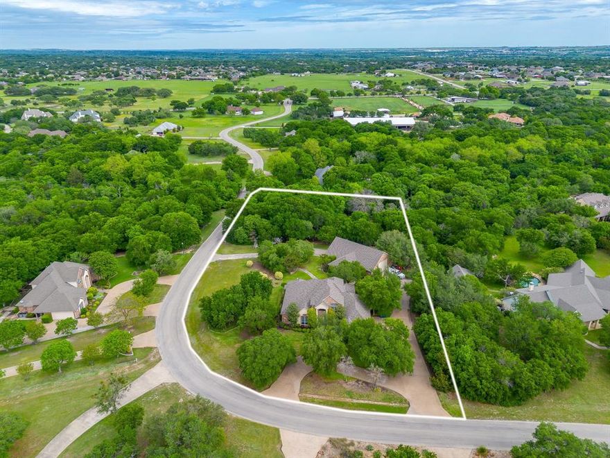 Gorgeous custom home in a gated neighborhood with an amazing workshop, all on 2 heavily treed acres.  Corner lot with a circle drive and a driveway that goes through the workshop which can be accessed by both sides of the street. Amazing finishes throughout with plantation shutters, crown molding, built-ins and much more. Formal dining of entry with access to the kitchen.  Large family room with a fireplace and built-ins with access to the kitchen with an island, an abundance of cabinets, and solid-surfaced countertops, open to large breakfast nook. Oversized primary suite with fireplace and ensuite with garden tub, separate shower, dual sinks, and wonderful closet for storage. Large utility room with built-ins and room for a fridge. Upstairs boasts a large second living room or game room with built-ins and 2 bedrooms with a jack-n-jill bathroom. Outdoors is a paradise with a large patio for entertaining, second patio with a built-in grill, fireplace and plenty of room for guests, and a third wood deck for entertaining. All overlooking the private space for wildlife. The workshop is a dream with one side for working or storage, a second side to park your RV or vehicles, and a full bathroom. 2 roll up doors to pull your vehicles in and use as a drive through to both sides of streets. A rare find in an amazing neighborhood and place to call HOME.