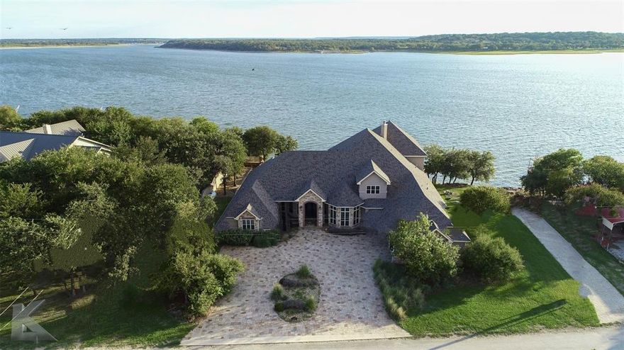 Luxurious 5 bedroom waterfront home located on some of the deepest water at Lake Brownwood.  The grand entryway draws you in to lovely entertaining spaces that flow out to the outdoor living space, stunning infinity pool & spa and on to the lake beyond.  Relax & entertain in the semi-enclosed outdoor kitchen-living center. Enjoy the lake & all the fun from your private boat ramp & oversized boat dock with enclosed heated & cooled fishing room. Secluded Primary Suite plus 3 other bedrooms, all with ensuite bathrooms, on first level. Upstairs you will find another bedroom with ensuite bathroom, game room, flex space (would make a great media room), plus a loft area with wet bar. Great wrap-around balcony overlooking the lake. RV Electric hookup at boat ramp. Start the day with a smile, spend your day on the lake & finish with a glass of wine from your private wine cellar which doubles as a safe room!  Gated Community.  See list of Additional Information uploaded with Seller's Disclosure.