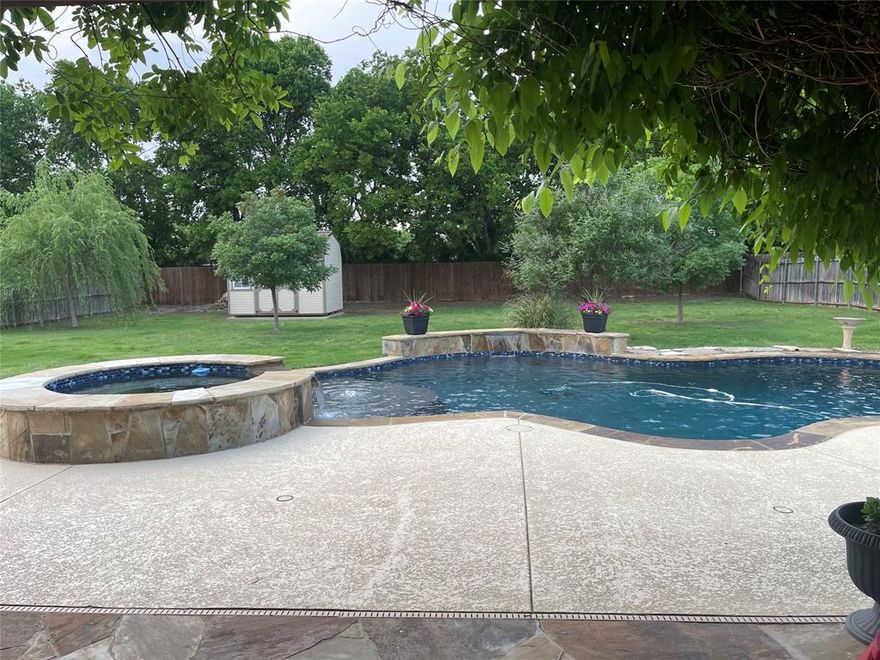 Price Improvement just in time for the pool to get plenty of use!! Step into this charming brick home designed for living large both inside and out, offering 4 spacious bedrooms and a thoughtfully designed floorplan that blends comfort with functionality. The moment you step through the front door, the open-concept design immediately impresses. Every major living space pivots naturally from the central great room, kitchen, dining, and oversized island— creating a layout that feels expansive, connected, and perfect for entertaining. The open-concept kitchen flows seamlessly into the living room and dining area, creating an inviting space perfect for everyday living or hosting gatherings. But the true showstopper is outside. Outside, your private retreat awaits. Enjoy a large (almost half an acre) fenced backyard, complete with an inground waterfall pool and spa ideal for beating the Texas heat, plus a with tanning ledge that offers the perfect place to relax, entertain, or spend long summer days with family and friends. Plus, an extraordinary cathedral-covered patio spanning nearly 20 feet with an outdoor fireplace that sets the scene for the yard itself is exceptionally large, providing plenty of room for pets, play, or future landscaping visions, cozy evenings under the stars. Whether you're entertaining friends or unwinding after a long day, this backyard is built for year-round enjoyment. Additional highlights include a well-maintained freestanding 2 story storage shed, ideal for tools, lawn equipment, or hobby space. Home has many updates and upgrades, a true must see!! If you're looking for a property where indoor flow meets outdoor living, this one delivers. This home truly has it all—space, style, and the perfect outdoor oasis.