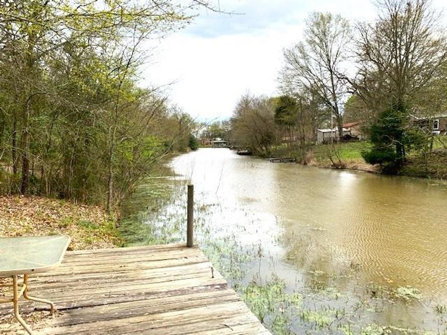 Lakefront property features approximately 1.34 acres, aerobic septic, community water, electricity, storage container, covered area for parking or partying on a quiet paved road. Wow everything you need is here. The property has a rock driveway and pad site with RV hook ups, is cleared with scattered nice large oaks and other shade trees. A 40’ container with spray in insulation water & electric on the property. Container has washer & dryer hook ups and is a great storage facility for your mower, lawn tools, ATVs or make it a man cave. Approximately 28.5x32.5 covered area has a gravel base with water and electric and is a great place for parking a 2nd RV, vehicles, boats or a place to party and dine outdoors.