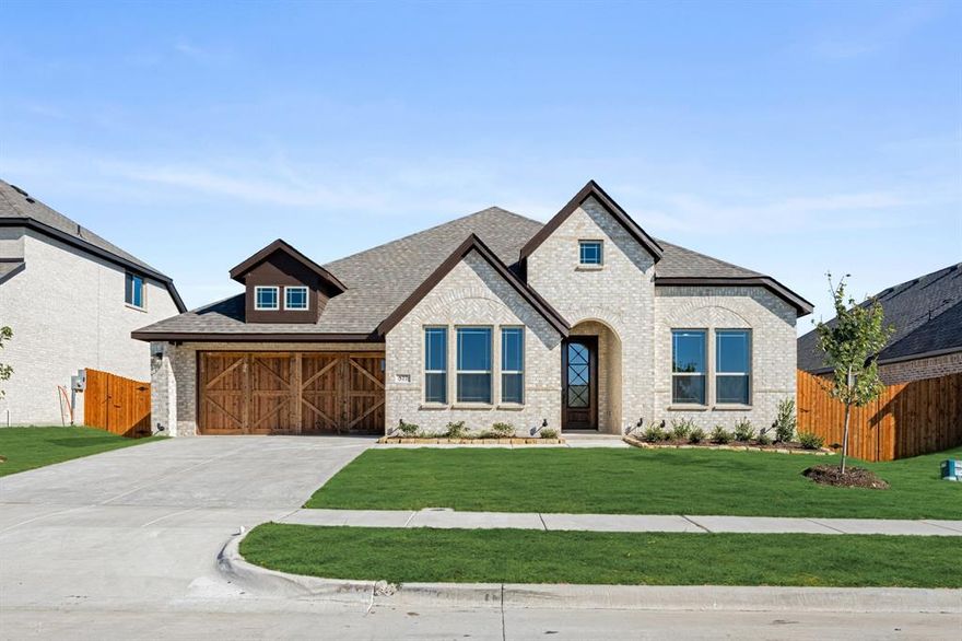 *Special financing available — ask for details!* MOVE-IN READY — A BRAND-NEW BLOOMFIELD HOME YOU CAN CALL YOURS TODAY! The Caraway plan offers 4 bedrooms, 2.5 baths, and a single-story layout that balances open-concept living with smart separation of spaces. The all-brick exterior with rich trim and an 8’ front door gives this home a strong first impression, while inside, wide entryways and wood-look floors flow through the main living areas for a clean, modern feel. The kitchen anchors the home with shaker-style cabinets in a champagne glaze, Playa White quartz countertops, stainless steel appliances, and a full tile backsplash that adds texture and brightness. The family room centers around a sleek tile fireplace topped with a thick oak mantle—an eye-catching focal point that's easy to imagine as the background for all your future memories! The primary suite sits in its own wing, featuring two individual vanity areas, a soaking tub, a tiled shower with a built-in bench, and a large walk-in closet designed for everyday ease - plus it has an exit directly into the laundry room! 3 additional bedrooms are grouped near the front, giving plenty of flexibility for guests, work, or hobbies. Throughout, recessed lighting, ceiling fans, and upgraded baseboards create a finished, high-end look. The covered back patio opens to a fully sodded yard with stone-edged landscaping and a sprinkler system already in place. Located in North Grove, one of Waxahachie’s premier master-planned communities offering trails, parks, and a resort-style pool, this move-in ready Bloomfield home combines polished design with lasting comfort. Come visit our model to learn more!