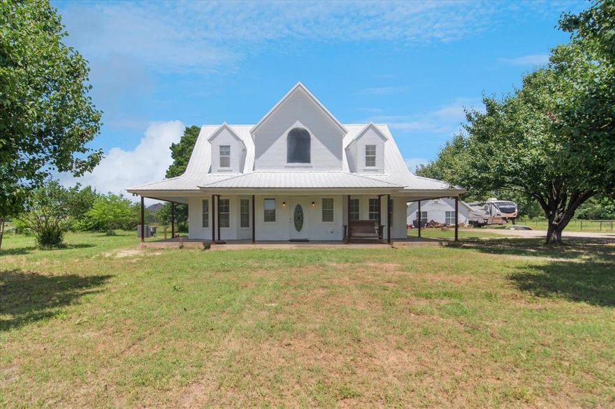 Discover the perfect blend of rustic allure and contemporary comfort in this beautifully maintained 3-bedroom, 2.5-bath farmhouse, situated on nearly 2 picturesque acres within the esteemed Caddo Mills ISD. This rural sanctuary epitomizes country living, while still being conveniently located just minutes from Greenville's amenities.
Step into a sunlit living space where traditional design meets modern updates. The main floor features a spacious master suite, offering a luxurious retreat with a Jacuzzi tub. Culinary enthusiasts will appreciate the remodeled kitchen, showcasing a butcher block island and updated appliances, setting the stage for culinary creativity. Revel in the elegant transition from indoor to outdoor living with atrium doors in every downstairs room, leading to a generous wraparound covered porch. The charming upstairs area boasts two large bedrooms, a full bath, and a versatile nook perfect for a home office or cozy reading hideaway.
This rural abode offers expansive outdoor space ideal for hosting gatherings or savoring quiet moments in nature. The wraparound porch provides panoramic views of the tranquil landscape, making it a perfect spot for morning coffee or evening relaxation. Enhance your hosting capabilities with a charming 2-bedroom, 1-bath guest house, featuring an open-concept living area that offers versatility as a guest suite, private office, or income-generating rental. The property's character is further enriched by a stunning wood-burning stone fireplace, perfect for cozy evenings.
Seize the opportunity to own a piece of serene countryside living with modern conveniences. For a personal tour of this stunning Greenville gem, contact the listing agent today and step closer to making this dream property your own.